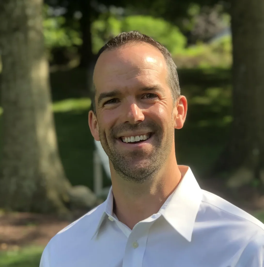 Chris Radvansky, founder of Rad Consultants, outdoors in a white shirt